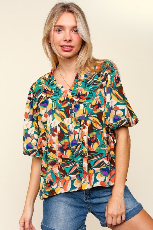 Blusa peplum con mangas abullonadas y volantes florales de tamaño completo de Haptics