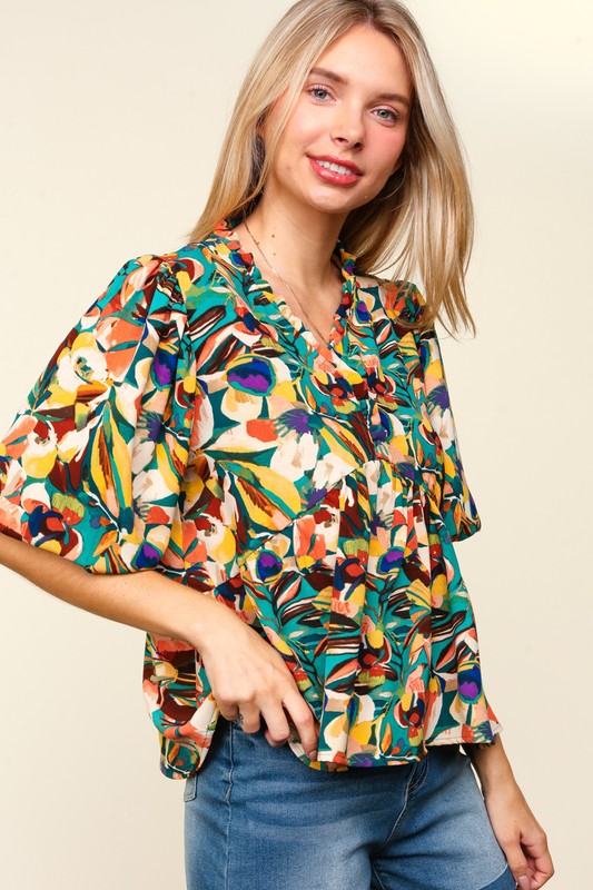 Blusa peplum con mangas abullonadas y volantes florales de tamaño completo de Haptics